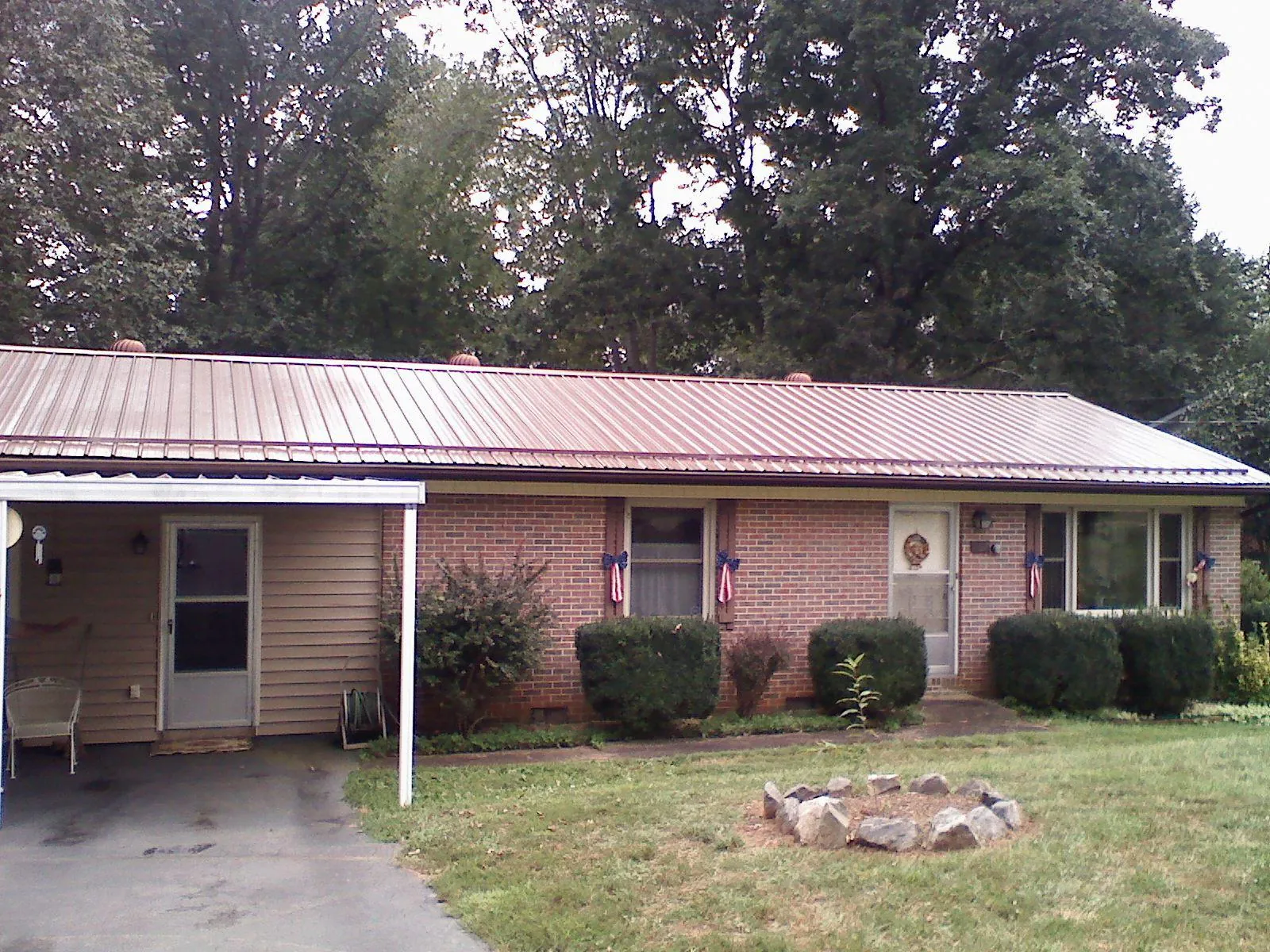 Bronze metal roof and carport on a brick ranch home — Roof Repair work by our crew in Lafayette Hill